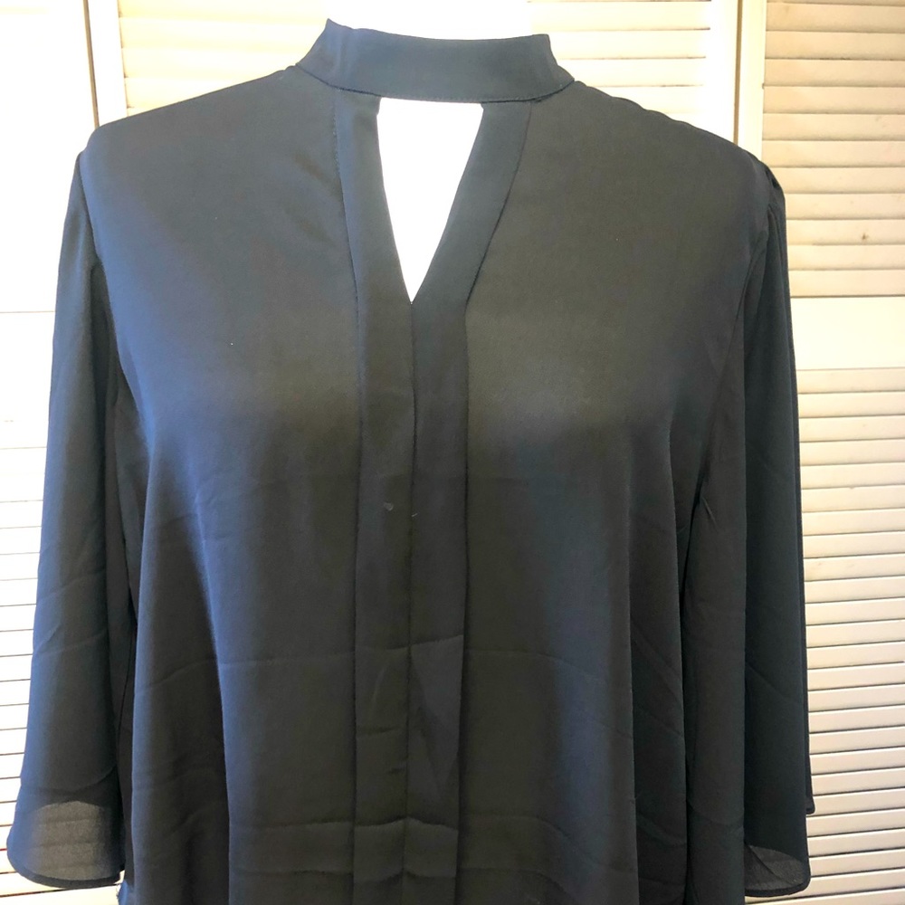 Black 100% Modish One polyester top. V cut in front. Wide sleeves.  Size XL.